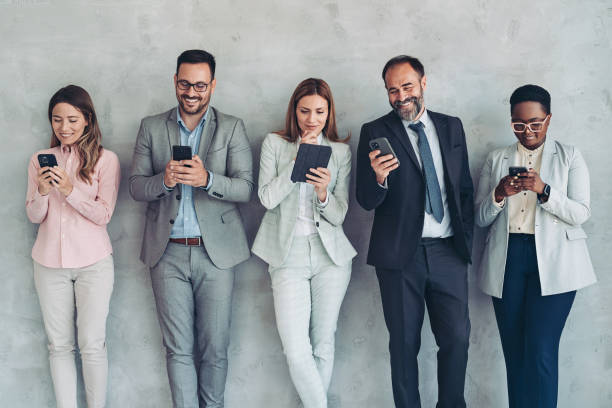 istock Business persons with smart phones and tablets 1415253933