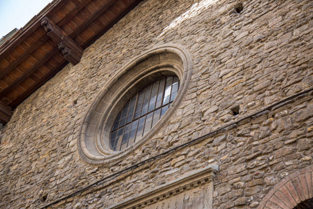 istock Large vintage round window with bars. Decorative element of an old renaissance building. 1415254077