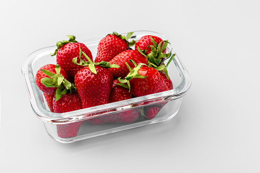 Glass box with fresh strawberries.  Vegetables in a glass containers. Food storage concept