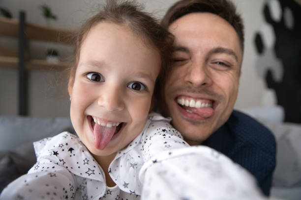 istock Joyful small cute kid girl having fun with happy father. 1415255183
