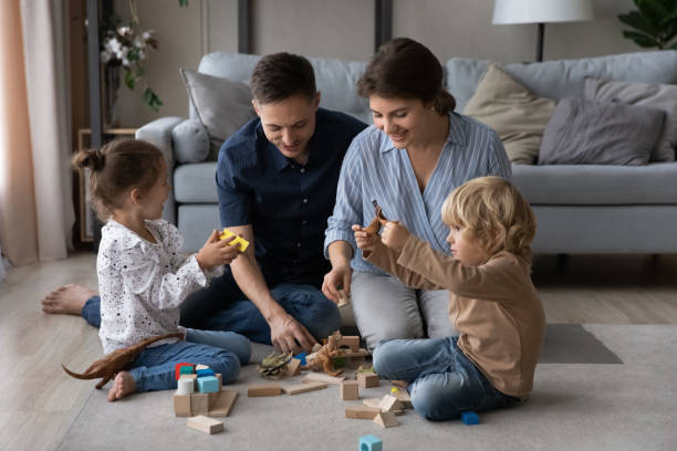 istock Affectionate millennial parents playing toys with little children. 1415255204