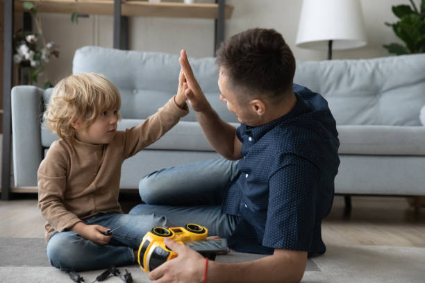 istock Adorable little kid giving high five to father. 1415255230