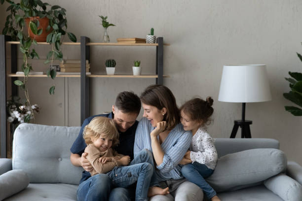 istock Happy caring father mother having fun with son daughter. 1415255263