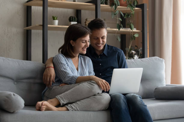istock Happy loving couple using laptop at home. 1415255911