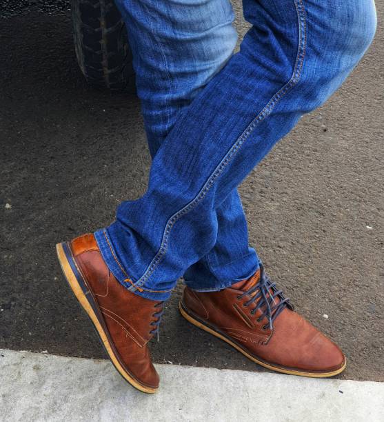 istock Man wearing blue denim jeans with brown leather shoes. 1415255994