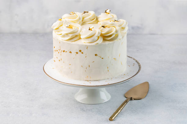 White cake on cake stand on the white background stock photo