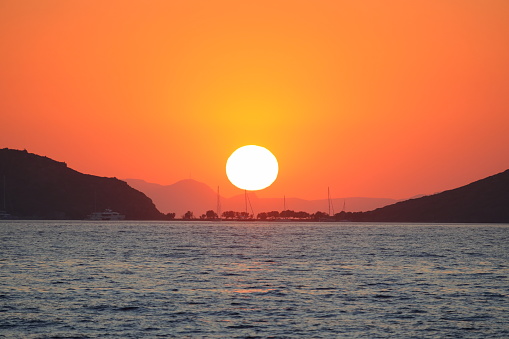 sunset on the beach. Seaside town of Turgutreis and spectacular sunsets. Selective Focus.