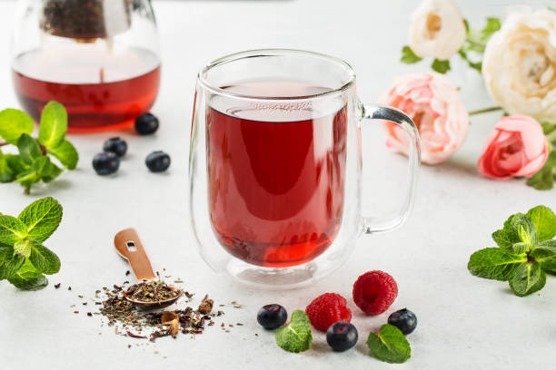 istock Raspberries and blueberries tea with fresh berries on white background 1415257584