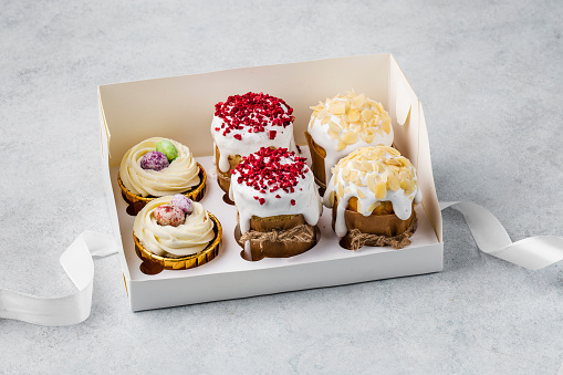 Delicious dessert in a white box with a ribbon on a white background