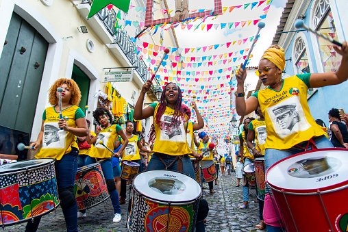 Salvador, Bahia, Brazil - June 22, 2018: Dida Band members play percussion instruments at Pelourinho in Salvador, before the match between Brazil vs Costa Rica for the 2018 soccer world cup in Russia.