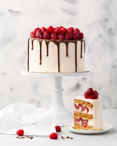 Raspberry cake, raspberry sponge cake with fresh raspberries and sour cream on a white background stock photo