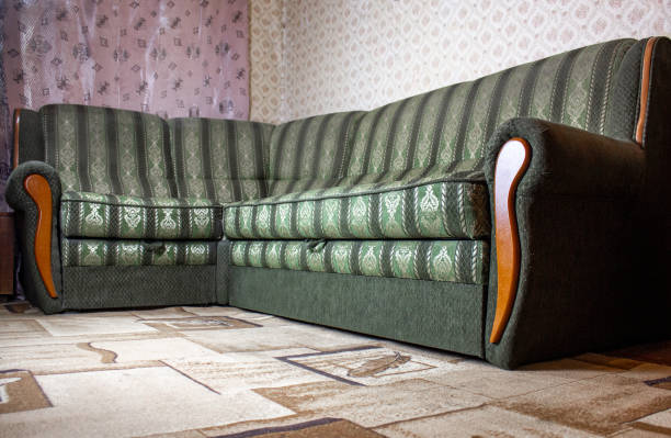 istock Sofa in the apartment. Green retro sofa. Vintage sofa interior design. 1415258514
