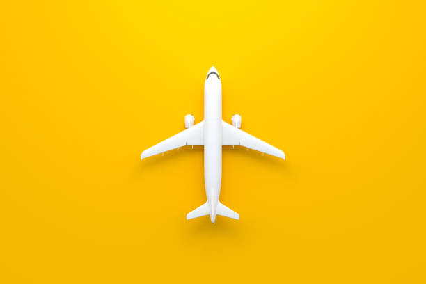 istock Airplane on a yellow background with copy space 1415259573