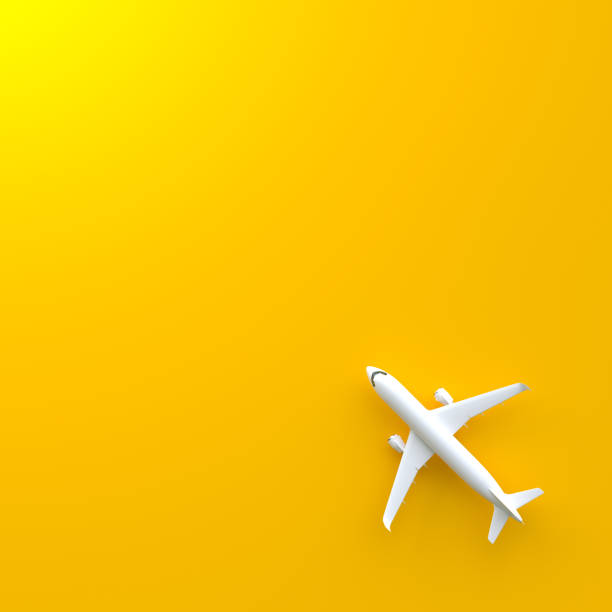 istock Airplane on a yellow background with copy space 1415259578