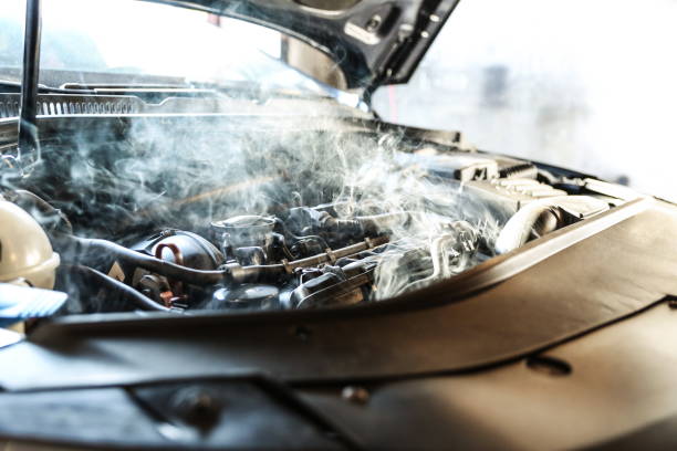 car engine overheating close up. car engine overheating close up. vehicle engine in smoke. short circuit in the car motor. car wiring fault. smoke or steam from a vehicle engine overheated photos stock pictures, royalty-free photos & images