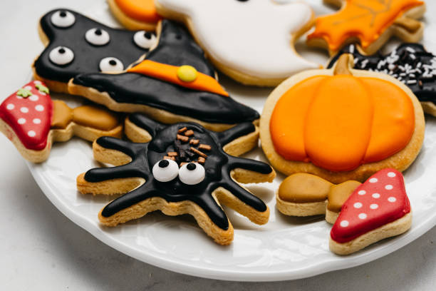 istock Halloween sugar cookies - pumpkin, ghosts, witch hat, spider in a plate 1415260487