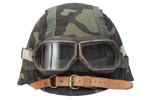 soviet army steel helmet with protective goggles and camouflage cover isolated on a white background