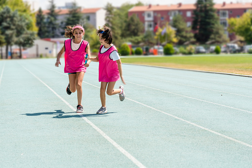 kids Passing the relay baton on the track field