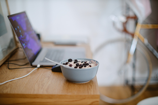 Oat meal breakfast ready at the living room table. Work from home concepts.