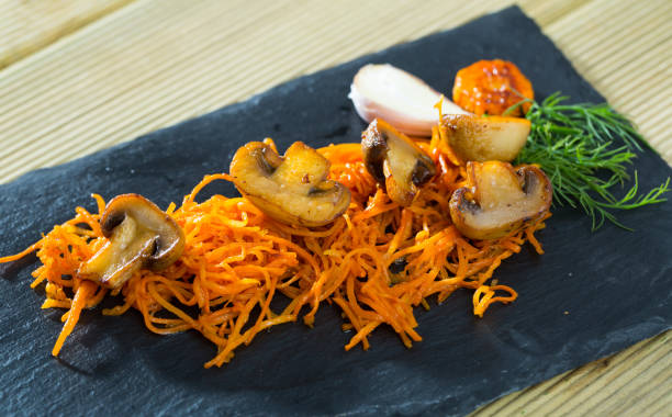 istock Roasted champignons with julienne carrots 1415268439
