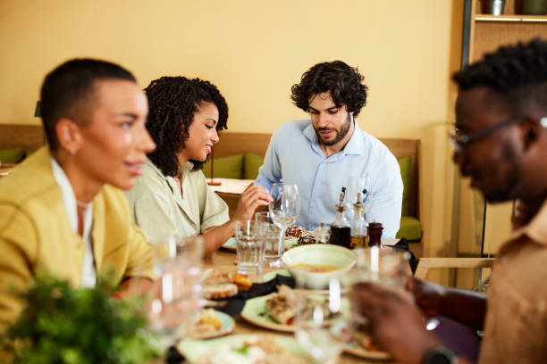 istock A Group of friends has dinner together in a restaurant. 1415269334
