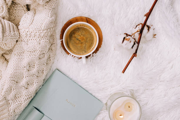 istock Flat lay with knitted warm sweater, candle and coffee on the bed. 1415269381