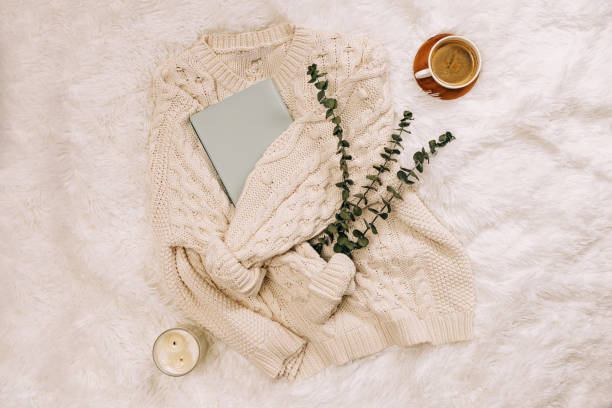 istock Knitted warm sweater, coffee, notepad and candle, 1415269384