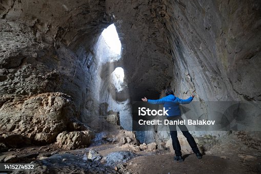 istock Tourist visiting the Eyes of God cave. 1415274532