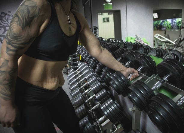 Sports equipment in gym. Dumbbells of different weight close up
