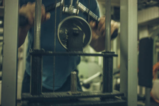 Adult man trains triceps in gym