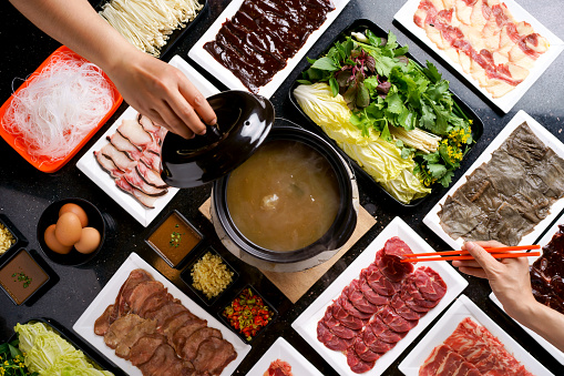 Top view, shabu-shabu or sukiyaki. Beef slice on top of hot pot, Fresh beef slices