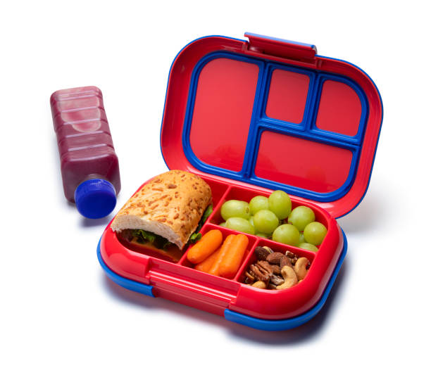 This is a conceptual photo with a children's school lunch on a White Background