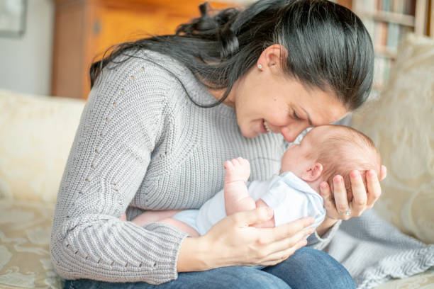 istock Young New Mother Holding Her Son on Her Lap 1415279634