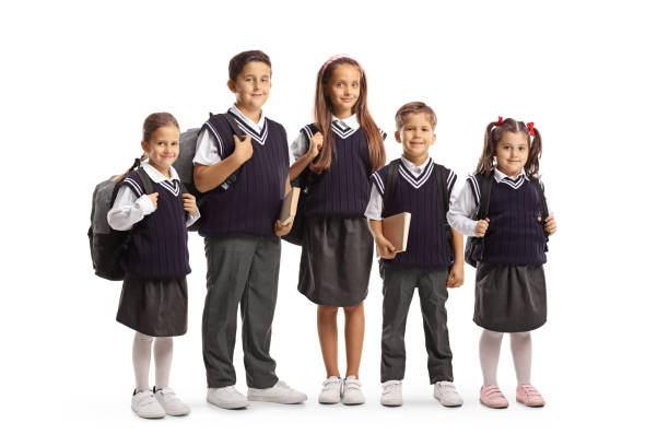 Younger and older schoolchildren in school uniforms isolated on white background
