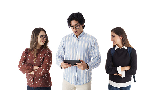 Three latin students  looking at a digital device.