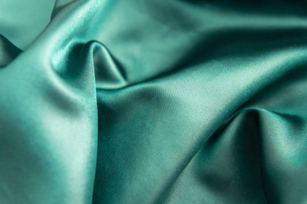 istock Soft pine green folded fabric with glitter that serves as a background or to place objects 1415282179