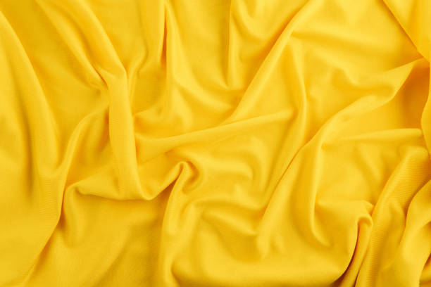 istock Elegant yellow wrinkled silk texture background that can be used for web pages, wallpapers, or product features 1415282185