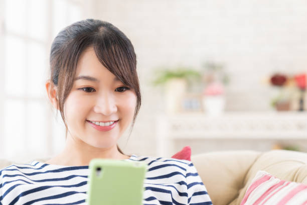 istock attractive Asian woman using a smart phone 1415283209