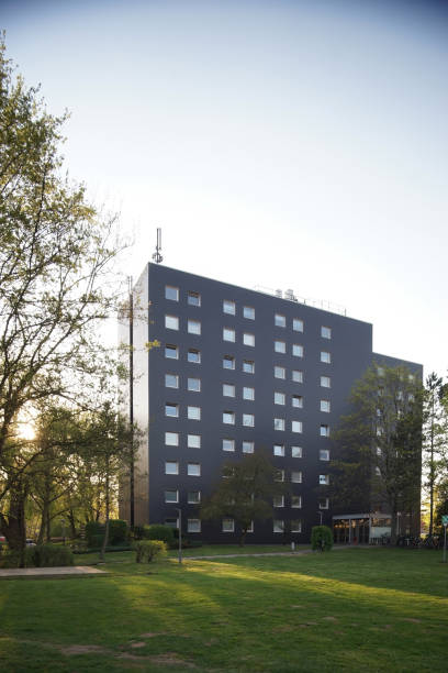 istock modern building with square windows, facade in dark gray, with sunset in the background 1415284072