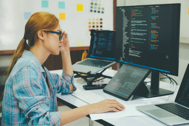 istock Young woman covering her face with the stress of work coding and programming software. 1415284358