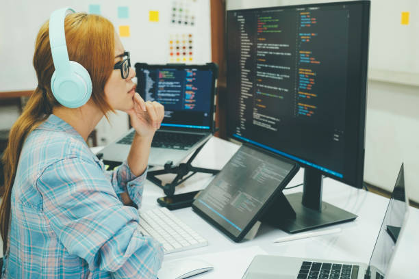 istock Young woman covering her face with the stress of work coding and programming software. 1415284360