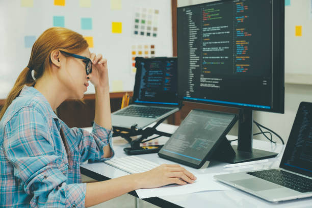 istock Young woman covering her face with the stress of work coding and programming software. 1415284361