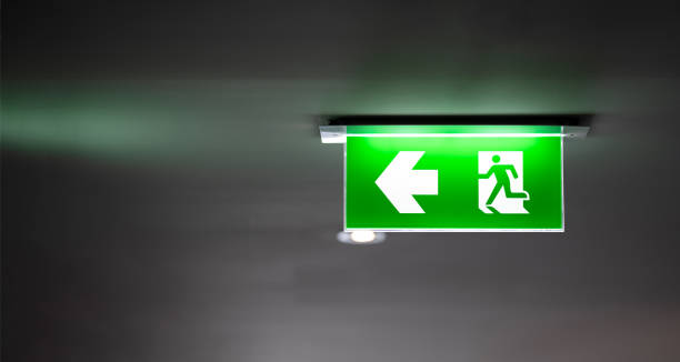 istock fire exit sign light box is hung on the ceiling in hotel walk way. 1415286964