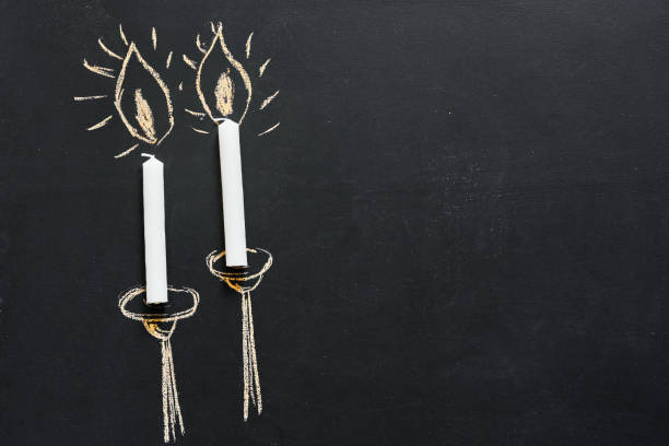 Two candles painted on a chalkboard with copy space. stock photo