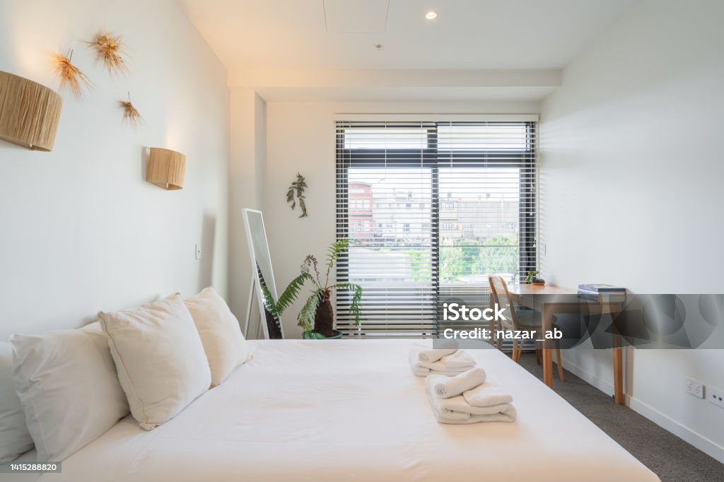 Apartment, spacious furnished bedroom. Beautiful view of white luxury furnished room. Table Stock Photo