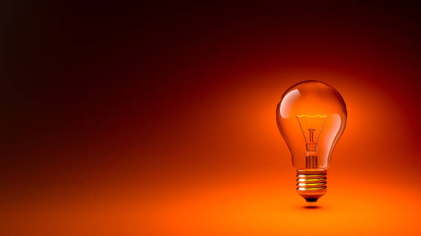 istock 3D Glowing Lightbulb Isolated Isolated on the Right of the Composition, on Dark Orange Gradient Background 1415291274