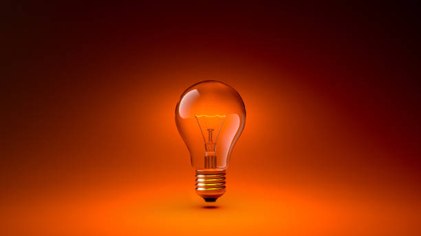 istock 3D Glowing Lightbulb Isolated Isolated on the Middle of the Composition, on Dark Orange Gradient Background 1415291279