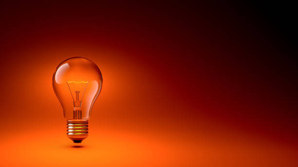 istock 3D Glowing Lightbulb Isolated Isolated on the Left of the Composition, on Dark Orange Gradient Background 1415291280