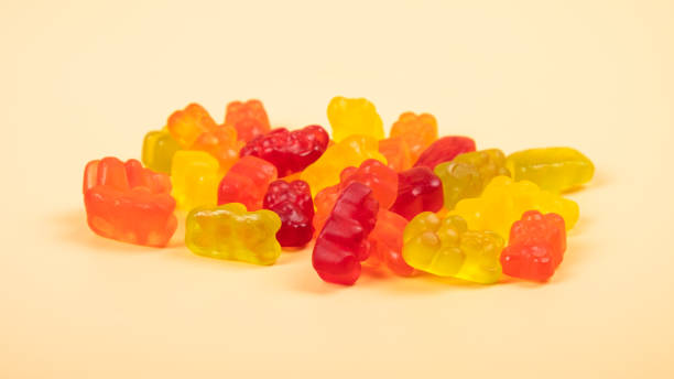 istock gummi bears jelly sweets closeup on yellow background 1415295894