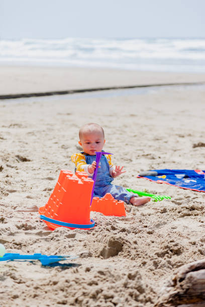 istock Happy Baby Enjoying the Beach 1415301310